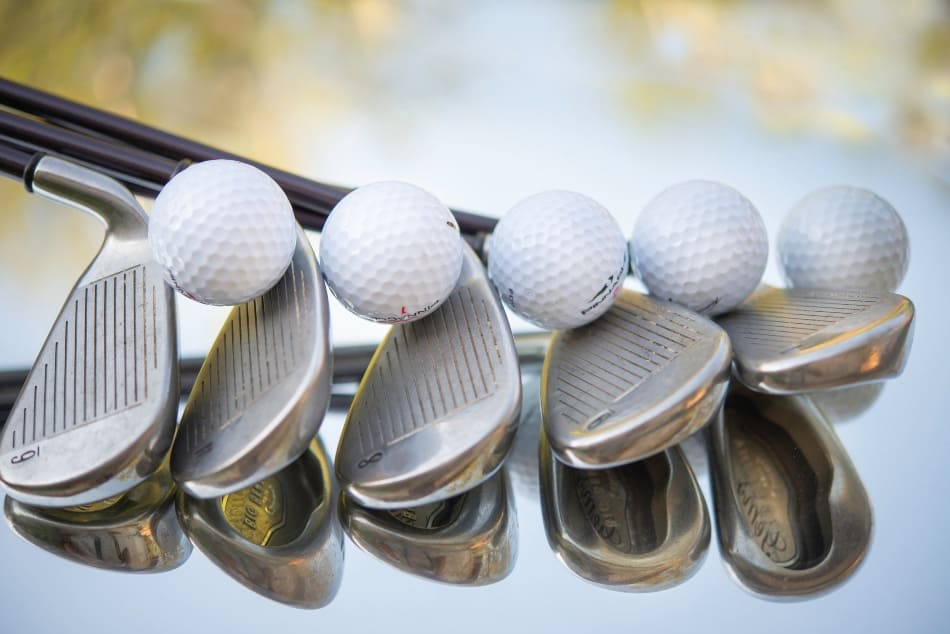 A golf ball and club. 