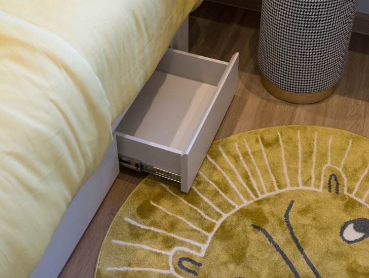 A bed with drawer.