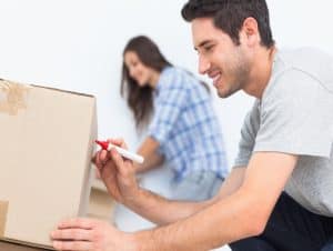 A man labeling the box.