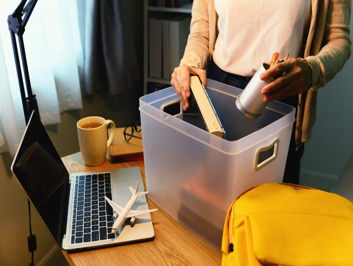 A student packing her things.