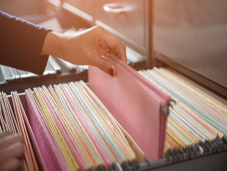 A person filling a document. 